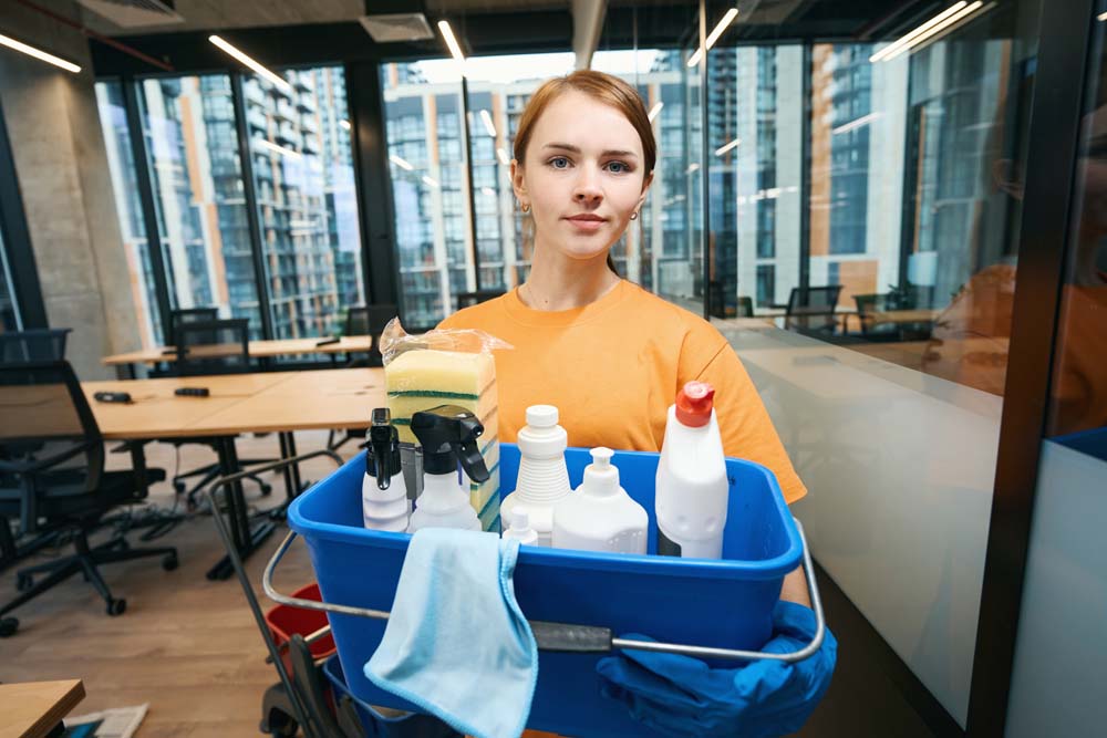 young woman holds professional cleaning kit